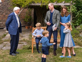 A handout photograph released by Kensington Palace on September 26, 2020, taken on September 24, 2020 in London, shows Britain's Prince William, Duke of Cambridge, Britain's Catherine, Duchess of Cambridge, Prince George (seated), Princess Charlotte and Prince Louis with Sir David Attenborough (L) in the gardens of Kensington Palace in London.