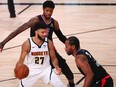 Denver Nuggets guard Jamal Murray handles the ball while Los Angeles Clippers guard Paul George and forward Kawhi Leonard during the first half in game seven of the second round of the 2020 NBA Playoffs at ESPN Wide World of Sports Complex.