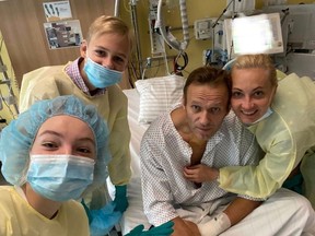 This handout picture posted on September 15, 2020 on the Instagram account of @navalny shows Russian opposition leader Alexei Navalny posing for a selfie picture with his family at Berlin's Charite hospital.