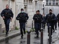 French police officers rush to the scene after people were injured near the former offices of the French satirical magazine Charlie Hebdo following an alleged attack by a man wielding a knife in Paris on September 25, 2020. The stabbing came as a trial was underway in the capital for alleged accomplices of the perpetrators of the January 2015 attack on the Charlie Hebdo weekly that claimed 12 lives.