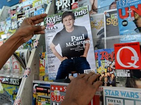 A vendor pulls out an issue of Rolling Stone  in Singapore. In 2016, a Singapore firm linked to one of Asia's richest families bought a 49 percent stake in the publication to expand the iconic US magazine's business in new markets, the two companies said.