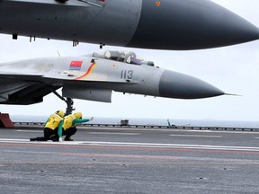 Chinese J-15 fighter jets on the deck of the Liaoning aircraft carrier during military drills in the South China Sea.