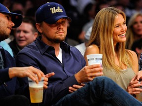 Actor Leonardo DiCaprio and girlfriend Bar Refaeli sit courtside on April 27, 2010, during the 2010 NBA Playoffs in Los Angeles, California.