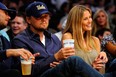 Actor Leonardo DiCaprio and girlfriend Bar Refaeli sit courtside on April 27, 2010, during the 2010 NBA Playoffs in Los Angeles, California.