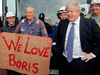 Britain’s Prime Minister Boris Johnson stands with working class supporters during a campaign in Middlesbrough, England on November 20, 2019.
