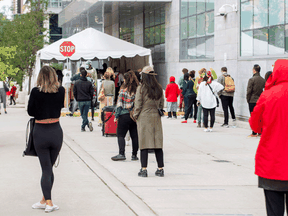 People wait in line at the Women's College COVID-19 testing facility in Toronto, September 18, 2020.