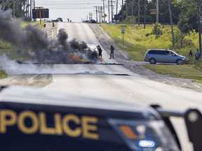 Indigenous protesters set fire to tires across a road in Caledonia, August 5, 2020.