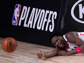 Toronto Raptors' OG Anunoby reacts after hitting the stanchion hard after being fouled by Boston Celtics' Daniel Theis on a breakaway shot during the second half of an NBA conference semifinal playoff basketball game Friday, Sept. 11, 2020, in Lake Buena Vista, Fla.