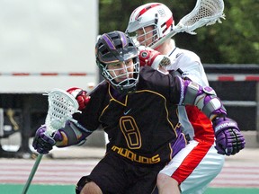 Delby Powless of the Iroquois Nationals eludes an England player during their opening game at the world lacrosse championships in London, Ont., in 2006.