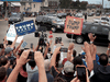 Trump supporters and Trump protesters watch as the motorcade carrying President Donald Trump passes by on September 1, 2020 in Kenosha, Wisconsin.