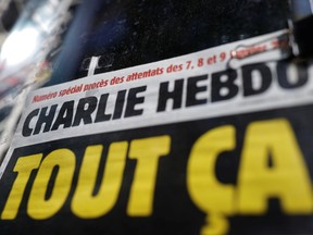 The front page of French satirical magazine Charlie Hebdo is seen at a newsstand in Paris on the opening day of the trial of the January 2015 Paris attacks against Charlie Hebdo, a policewoman in Montrouge and the Hyper Cacher kosher supermarket, on Sept. 2.