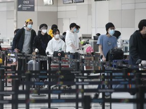 Passengers headed out on an afternoon flight from Pearson International Airport headed to Beijing are suiting up to fly back home to China and not taking any precautions on Wednesday May 6, 2020.