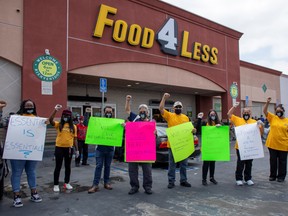 Workers picket outside a grocery store in Los Angeles on Aug. 5.