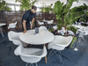 Harbour 60 employee Tom Agelopoulos cleans the restaurant’s parking lot patio.