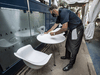 Harbour 60 employee Tom Agelopoulos prepares the restaurant’s parking lot patio.