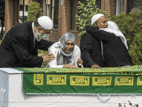 Family of murder victim Mohamed-Aslim Zafis mourn at a funeral service at the International Muslim Organization of Toronto, Wednesday September 16, 2020.