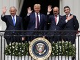 Israeli Prime Minister Benjamin Netanyahu, from left, U.S. President Donald Trump, Bahrain Foreign Affairs Minister Abdullatif bin Rashid Al Zayani and UAE Foreign Affairs Minister Abdullah bin Zayed Al Nahyan wave from a White House balcony after signing the Abraham Accords on Sept. 15, 2020.