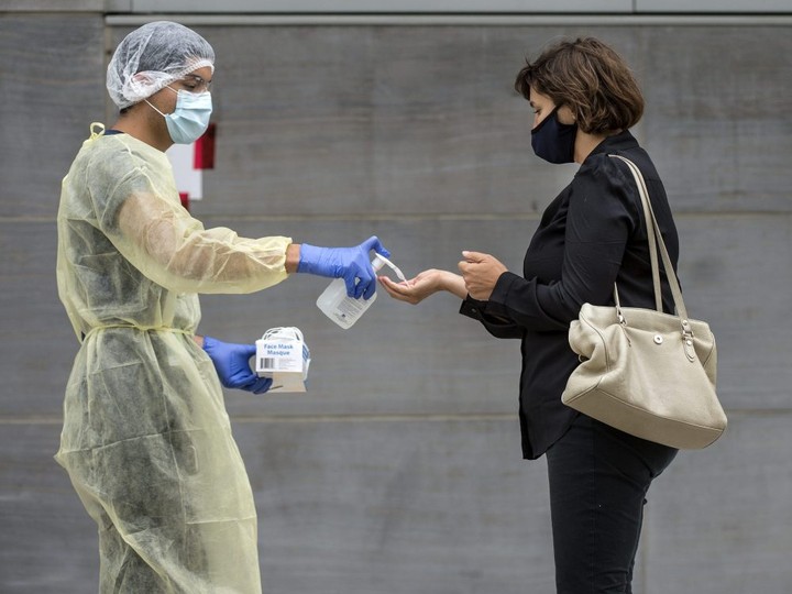  People speak with a health care professional while waiting in the queue to get a Covid-19 test at Women’s College Hospital in Toronto, Tuesday September 8, 2020.