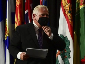 Ontario Premier Doug Ford leaves a press conference in Ottawa on Friday, Sept. 18, 2020. On Tuesday, Ford announced that nearly $70 million has been used to purchase 5.1 million doses of flu vaccine in the hopes of preventing a 'twindemic' — a rise in cases due to infections with the seasonal flu and COVID-19 — and keeping hospital capacity down.
