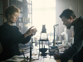 Rosamund Pike and Sam Riley play the Curies, shown here in a rare moment of non-backbreaking labour.