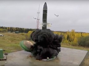 In this photo taken from undated footage distributed by the Russian Defence Ministry Press Service, an intercontinental ballistic missile lifts off from a silo somewhere in Russia.