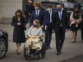 Loretta Traynor (on wheelchair), her son Samuel, and members of her family arrive for the funeral of her husband Christopher Traynor and their children Bradley, 20, Adelaide, 15, and Joseph, 11, at St. Mary of the People Catholic Church in Oshawa, Ont. on Thursday, September 17, 2020.