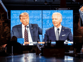 People watch the first televised presidential debate between Donald Trump and Joe Biden at a sports bar in Washington, D.C., on Sept. 29, 2020.