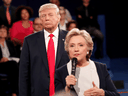Republican U.S. presidential nominee Donald Trump listens as Democratic nominee Hillary Clinton answers a question from the audience during a debate on October 9, 2016.