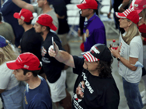 People wait for U.S. President Donald Trump to arrive at a campaign rally in Henderson, Nevada, September 13, 2020.