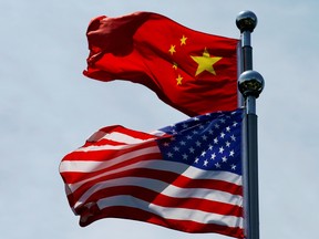FILE PHOTO: Chinese and U.S. flags flutter near The Bund in Shanghai