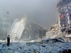 A man stands in the rubble and calls out asking if anyone needs help, in this photo taken on September 11, 2001,  after the collapse of the first World Trade Center Tower in New York.