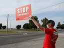 Wes Janz, of Indianapolis, holds up a sign across the road from the Federal Correctional Complex in protest of the execution of William LeCroy on Tuesday, Sept. 22, 2020,