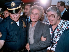 Soviet dissident Yuri Fyodorovich Orlov, centre, arrives in New York after being exiled from the Soviet Union in 1986.