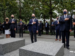 Democratic presidential nominee and former Vice President Joe Biden and his wife Jill, former New York City Mayor Michael Bloomberg, U.S. Vice President Mike Pence and his wife Karen all stand with their hands over their hearts as they attend ceremonies marking the 19th anniversary of the September 11, 2001 attacks on the World Trade Center at the 911 Memorial & Museum in New York City, New York, U.S., September 11, 2020.