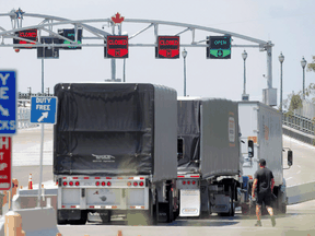Trucks prepare to cross The Peace Bridge, which runs between Canada and the United States, over the Niagara River in Buffalo, New York, July 15, 2020. Increased purchasing by consumers has brought cross-border trucking back to near normal levels.