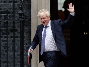 Britain's Prime Minister Boris Johnson waves as he leaves 10 Downing Street in central London on September 8, 2020 to walk across to the Foreign, Commonwealth & Development Office (FCDO) to chair the weekly meeting of the cabinet.