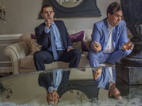 Jack Burkman, light blue suit, and Jacob Wohl, dark suit, in Burkman's home/office in Arlington, Va., in May 2019.