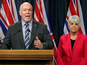 Premier John Horgan is joined by Finance Minister Carole James during a press conference at Legislature in Victoria, B.C., on Wednesday, May 15, 2019. The British Columbia government is expected to reveal how it plans to stimulate an economic rebound from the COVID-19 pandemic today. Horgan and James are scheduled to release details of the $1.5-billion economic recovery plan this afternoon.