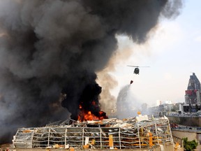 Lebanese firefighters try to put out a fire that broke out at Beirut's port area, on September 10, 2020.