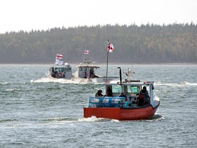 Members of the Potlotek First Nation, head out into St. Peters Bay from the wharf in St. Peter's, N.S. as they participate in a self-regulated commercial lobster fishery on Thursday, Oct. 1, 2020.