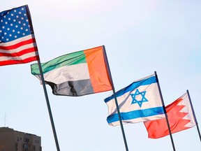 A road is decorated with the flags of (L-R) the US, the United Arab Emirates, Israel and Bahrain, in the resort city of Netanya in central Israel, on September 13, 2020.