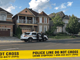 York Regional police officers stand outside of a Markham, Ont., home after four bodies were found, July 28, 2019.