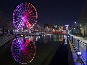 The Ferris Wheel is lit to the colours of the rainbow in solidarity to healthcare workers in Montreal, on Monday, April 6, 2020. A group representing amusement fair operators is calling for government support, saying the COVID-19 pandemic has dealt a severe blow to the industry.