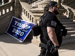 Second Amendment protesters listen to gun-rights advocates speak about the importance of the second amendment during a rally on the Michigan Capitol Building lawn on September 17, 2020 in Lansing, Michigan.