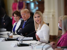 U.S. President Donald Trump and his daughter and advisor Ivanka Trump (C) attend an American Workforce Policy Advisory Board Meeting in the East Room of the White House in Washington, DC on June 26, 2020.
