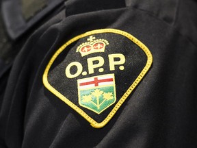 An Ontario Provincial Police logo is shown during a press conference in Barrie, Ont., on April 3, 2019. Provincial police remain on the scene today in an Ontario town where hundreds of modified cars descended this weekend for stunt driving, racing and other alleged dangerous driving behaviours. OPP Sgt. Jason Folz says the "car takeover" in Wasaga Beach, Ont. began Friday and continued early Sunday.THE CANADIAN PRESS/Nathan Denette