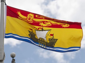 New Brunswick's provincial flag flies on a flag pole in Ottawa, Friday July 3, 2020. New Brunswick is reporting two new cases of COVID-19. Health authories say one them is a person in their 40s from Fredericton who got sick while travelling in Ontario and is now recovering there.