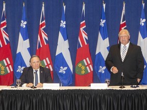 Ontario Premier Doug Ford stands alongside Quebec Premier Francois Legault, as he speaks to the media, at the start of the Ontario-Quebec Summit, in Toronto, on September 9, 2020. Four conservative-minded premiers are to issue today their wish list for next week's throne speech on which the fate of Justin Trudeau's minority Liberal government could hinge. Quebec's Francois Legault, Ontario's Doug Ford, Alberta's Jason Kenney and Manitoba's Brian Pallister plan to hold a news conference in Ottawa to spell out what they hope to see in the speech.