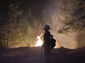 This photo provided by the Unified Fire Authority shows a Utah fire crew member on the scene working to protect the town of Butte Falls in southern Oregon on Sunday, Sept. 13. 2020. Two hundred British Columbia firefighters are heading to Oregon to help with devastating wildfires in that state