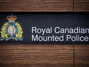 The RCMP logo is seen outside Royal Canadian Mounted Police "E" Division Headquarters, in Surrey, B.C., on Friday April 13, 2018. Two RCMP officers who were charged in the shooting death of a 31-year old man in northern Alberta two years ago are now facing manslaughter charges.